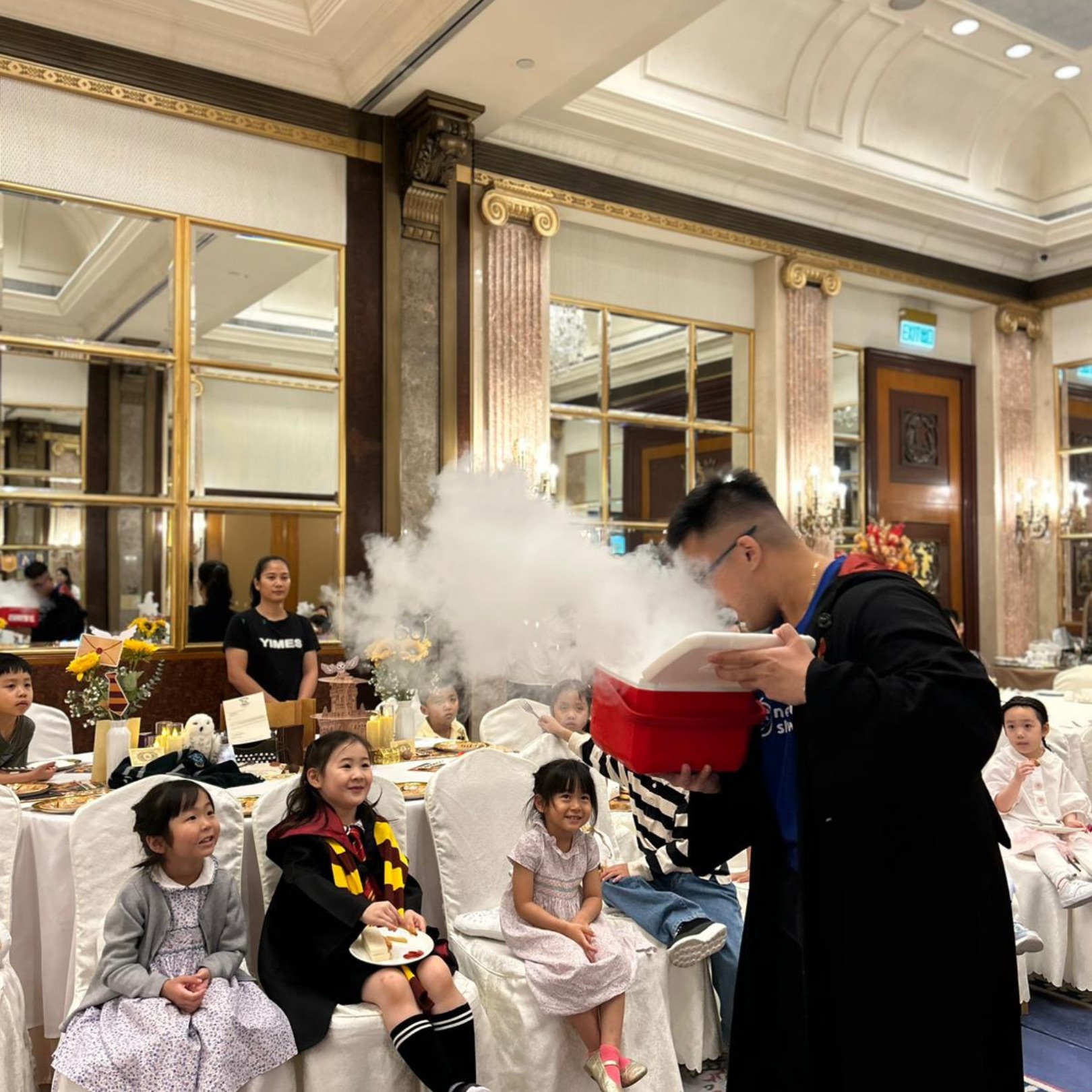 Newtonshow host creating a cloud of dry-ice fog at a birthday party