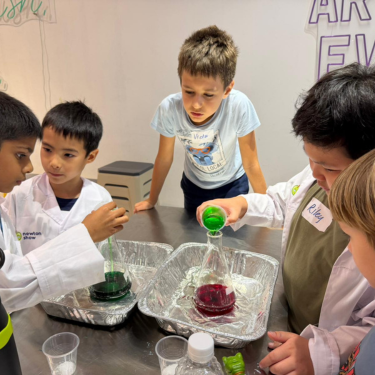 Children gathered around a colourful chemistry experiment at a Newtonshow Hong Kong kids' science camp