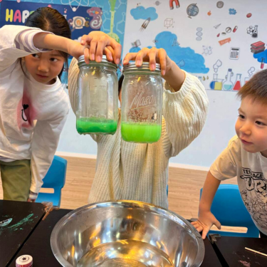 Kids in lab coats exploring a chemistry experiment, marking Newtonshow's expansion into Asia