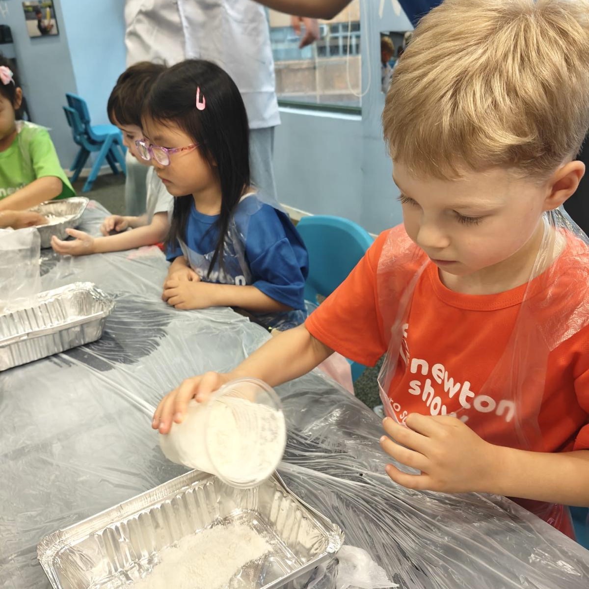 Children working through hands-on science trays at a Newtonshow camp