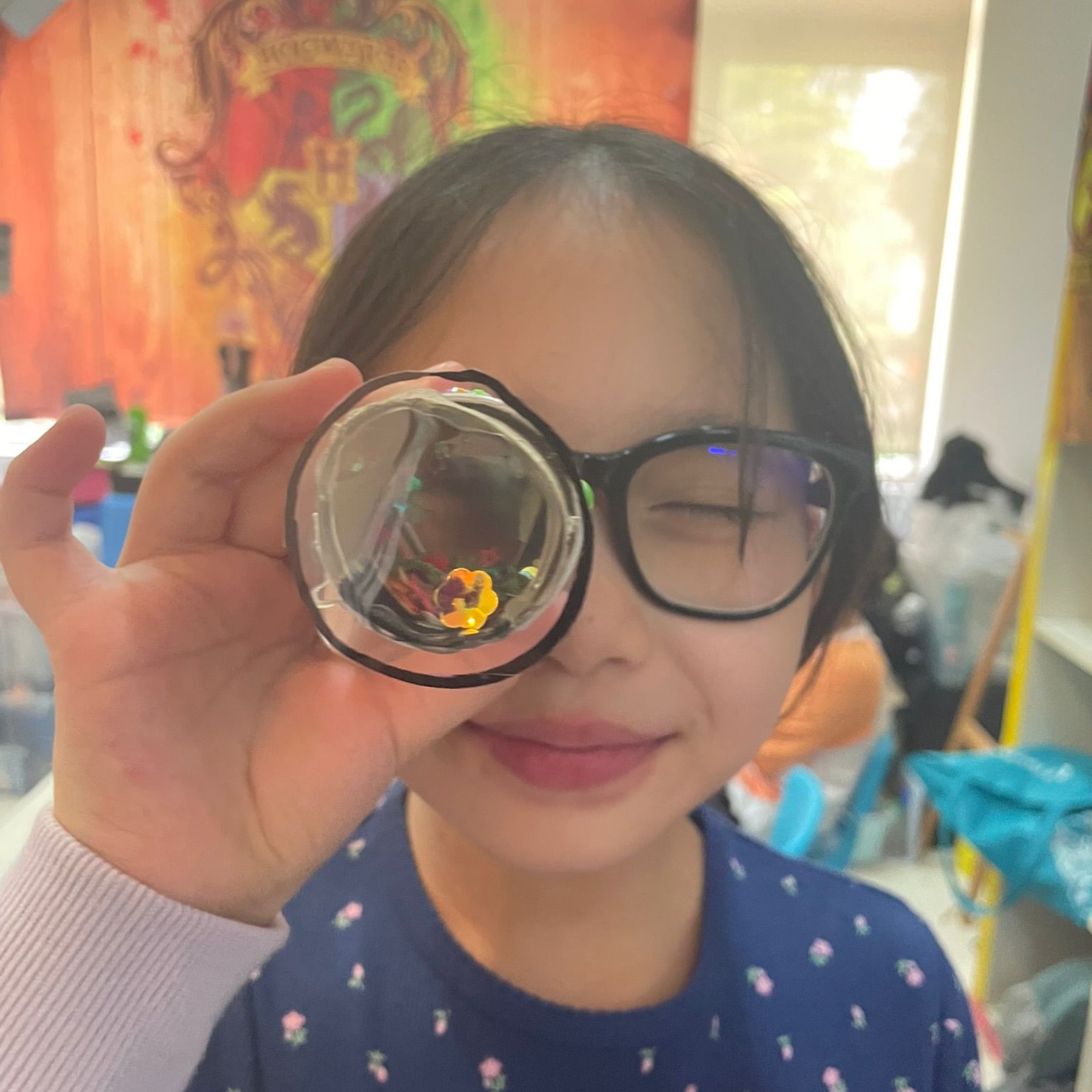 Girl peering through a magical lens during a challenge at a Newtonshow wizard science party