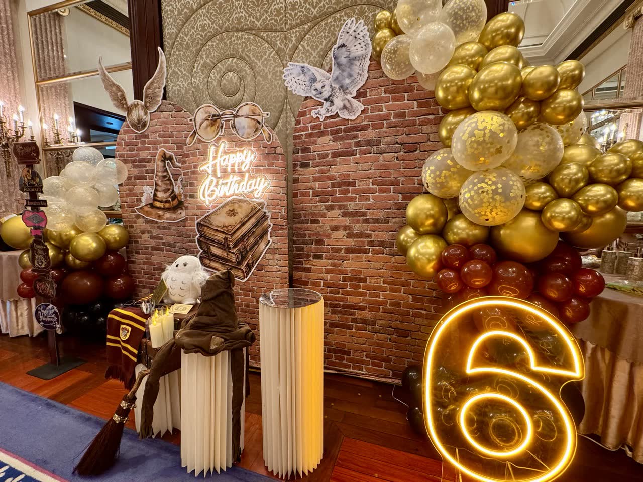 Wizard-themed birthday party backdrop with gold balloons and neon number at Newtonshow Hong Kong