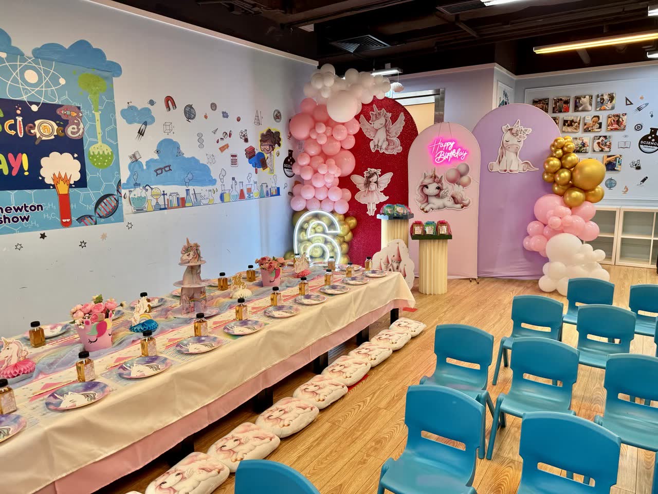 Long pink party table with cake stand and cupcakes at a Newtonshow party