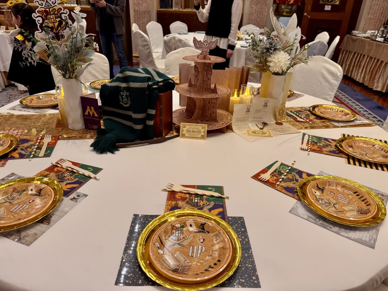 Wizard-themed party table with tiered dessert stand at Newtonshow